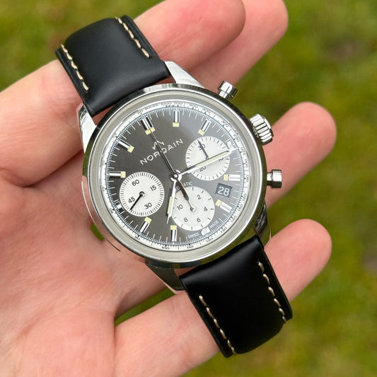 Oxford black full grain calf skin watch strap with contrast ivory stitching. Watch strap placed on the a Norqain chronograph.