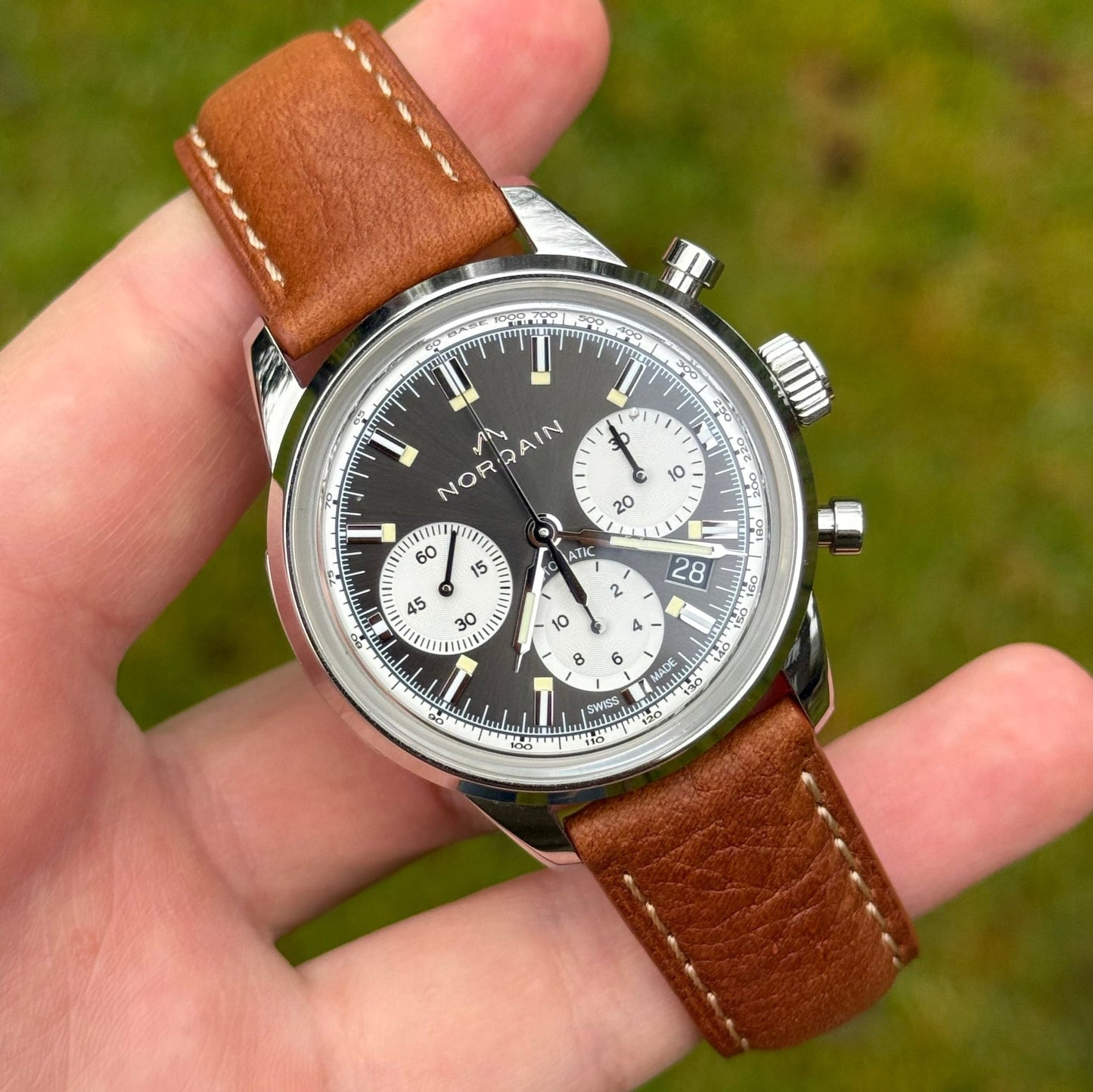 Rome copper tan Italian leather watch strap on the Norqain freedom chronograph. Contrast ivory stitching. Full grain leather
