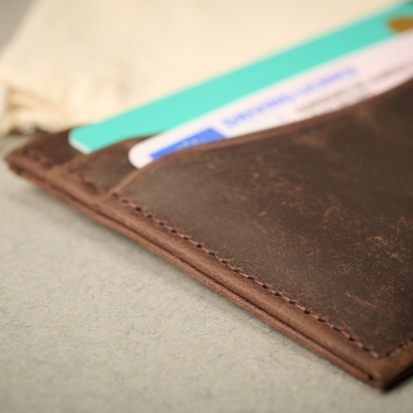 Close up of the Oxford brown full grain calf skin card case with cards. RFID blocking technology.