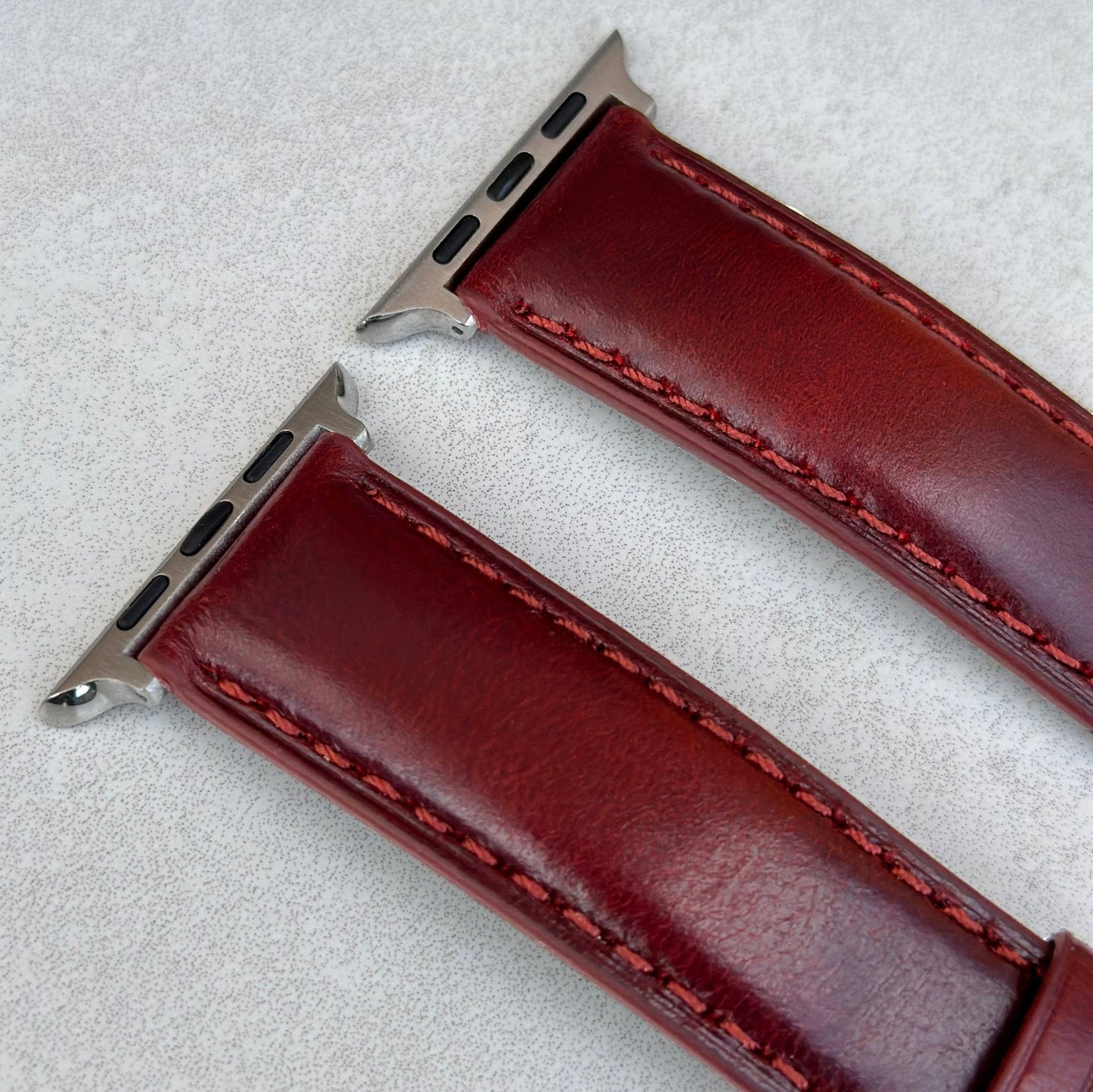 Top of the Athens wine red full grain leather watch strap. Strong red stitching. 316L stainless steel Apple Watch connectors.