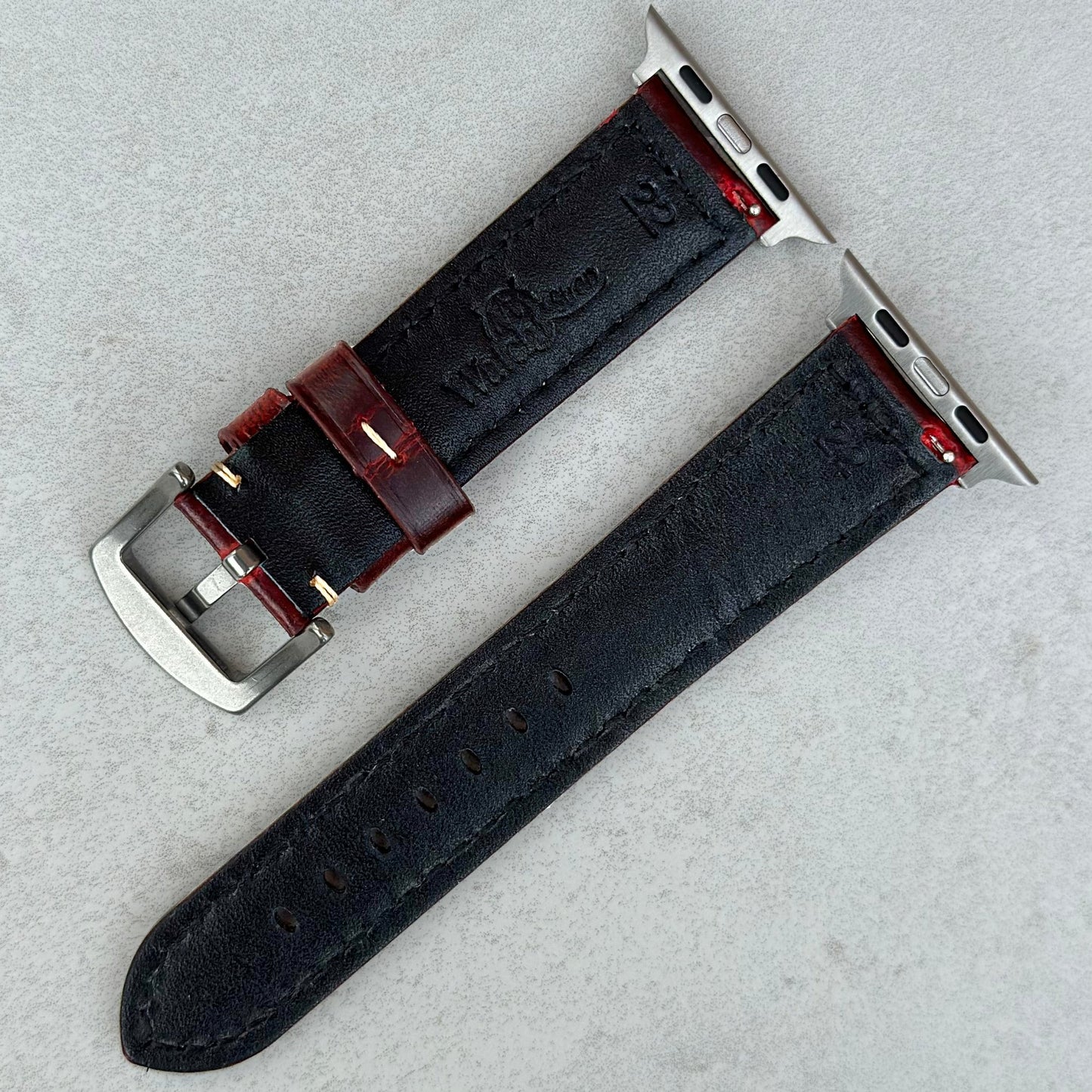 Underside of the Berlin burgundy full grain leather Apple Watch strap. Watch And Strap logo.