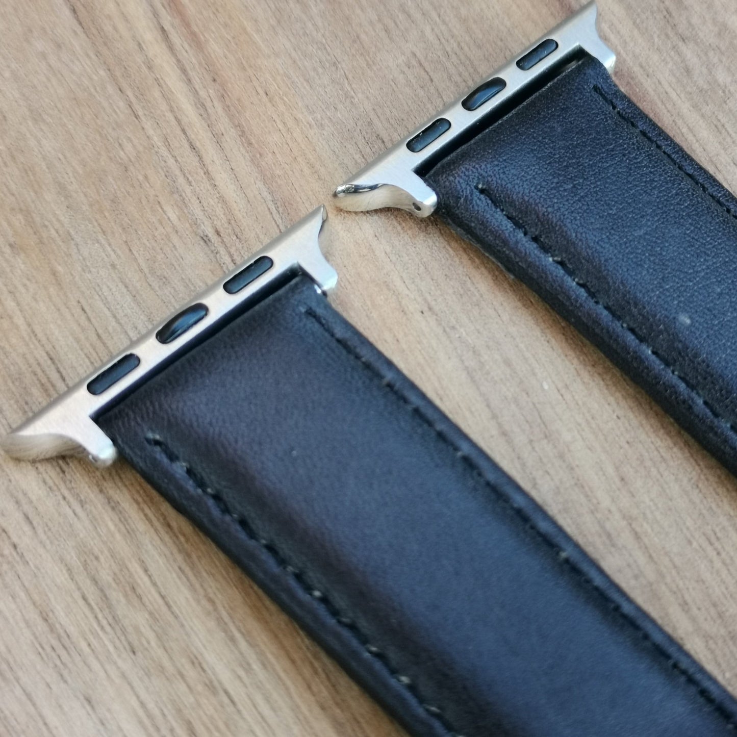 Close up of the Milan black leather apple watch strap.
