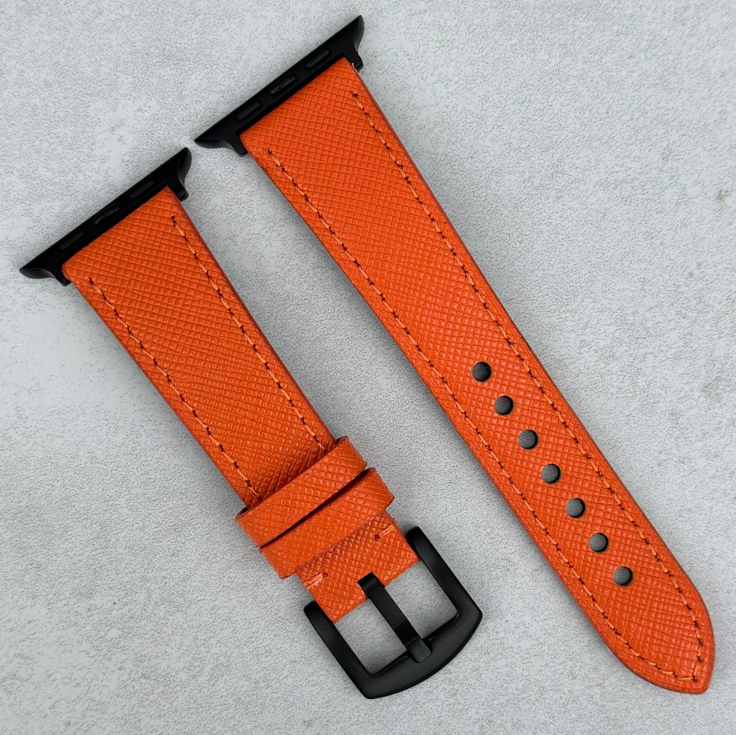 Orange Saffiano leather Apple Watch Strap. PVD black hardware. Apple Watch Series 3, 4, 5, 6, 7, 8, 9, SE and Ultra.