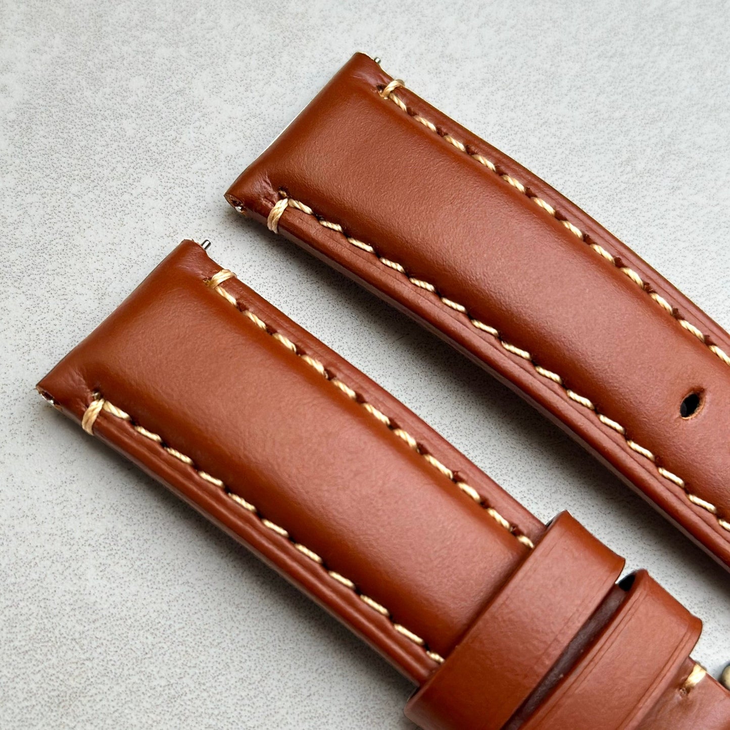 Top of the Oslo caramel brown full grain leather watch strap. Padded leather strap. Contrast ivory stitching. Watch And Strap