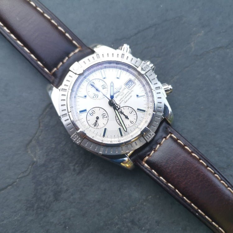 Berlin brown leather watch strap placed on the Breitling Evolution Chronomat. On a slate background. Watch And Strap.
