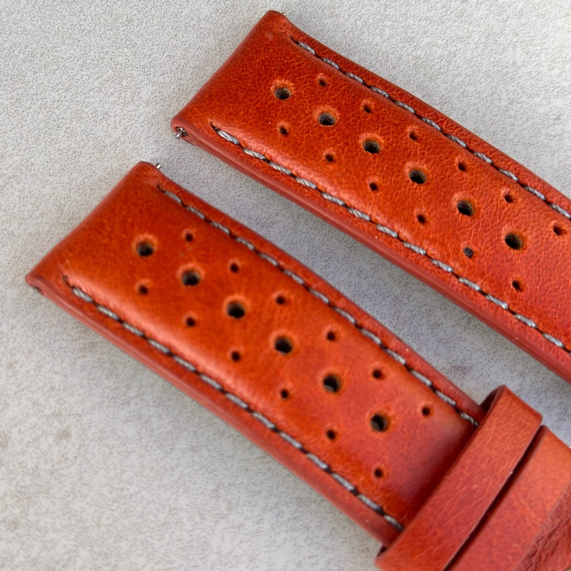 Top of the Montecarlo orange perforated full grain leather watch strap. Contrast grey stitching. Watch And Strap.