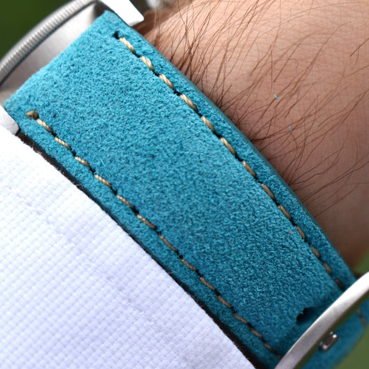 Wrist shot of the Paris turquoise suede Apple Watch strap. Contrast ivory stitching. Watch And Strap.
