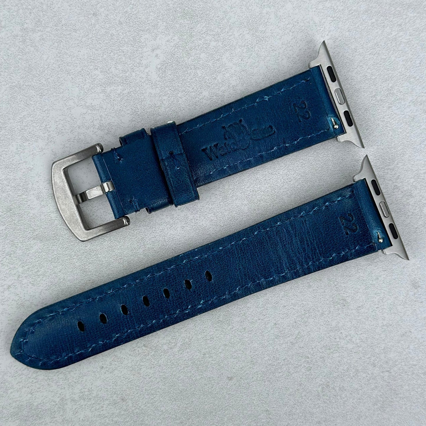 Rear of the Prague marine blue full grain leather Apple Watch strap. Watch And Strap logo.