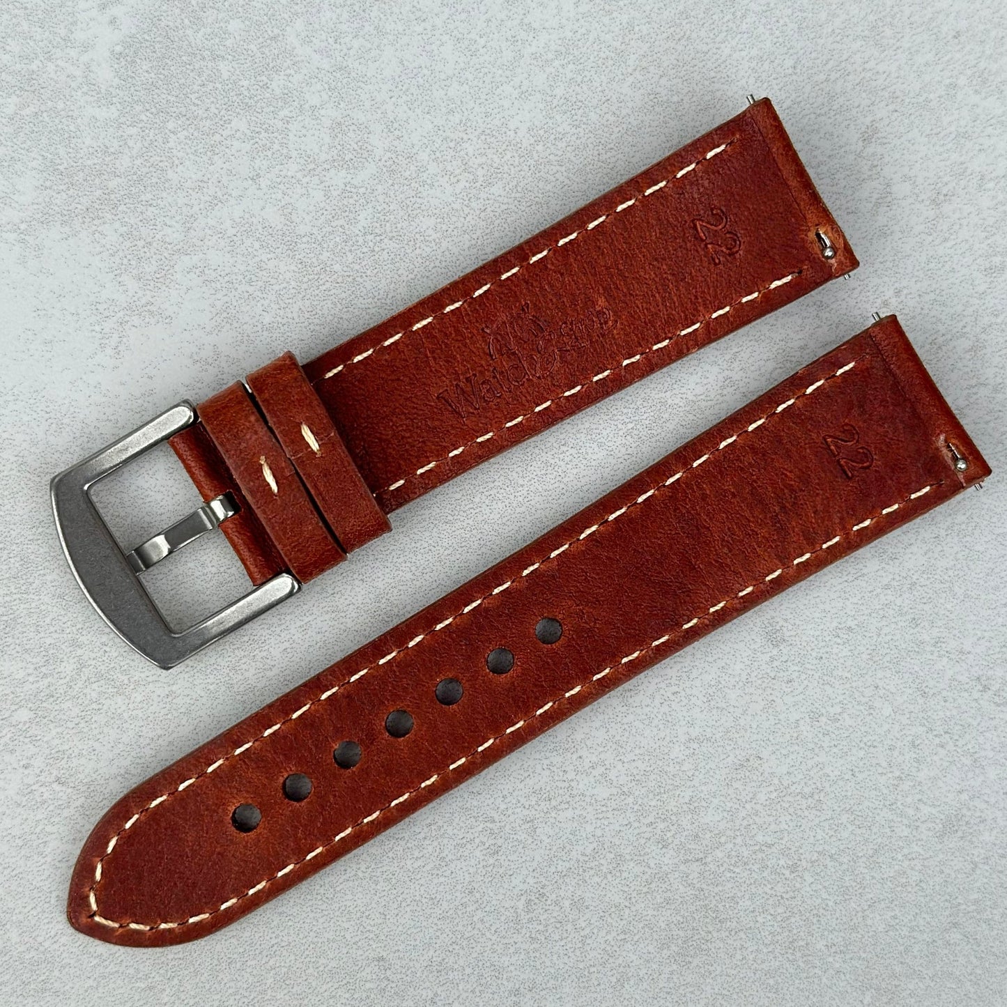 Rear of the terracotta brown full grain leather watch strap. Contrast ivory stitching. Quick release pins. Watch And Strap
