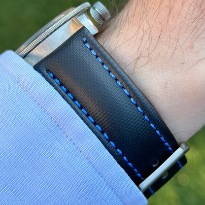 Wrist shot of the Bermuda jet black sail cloth watch strap with contrast blue stitching. On the Tudor Blackbay 58.