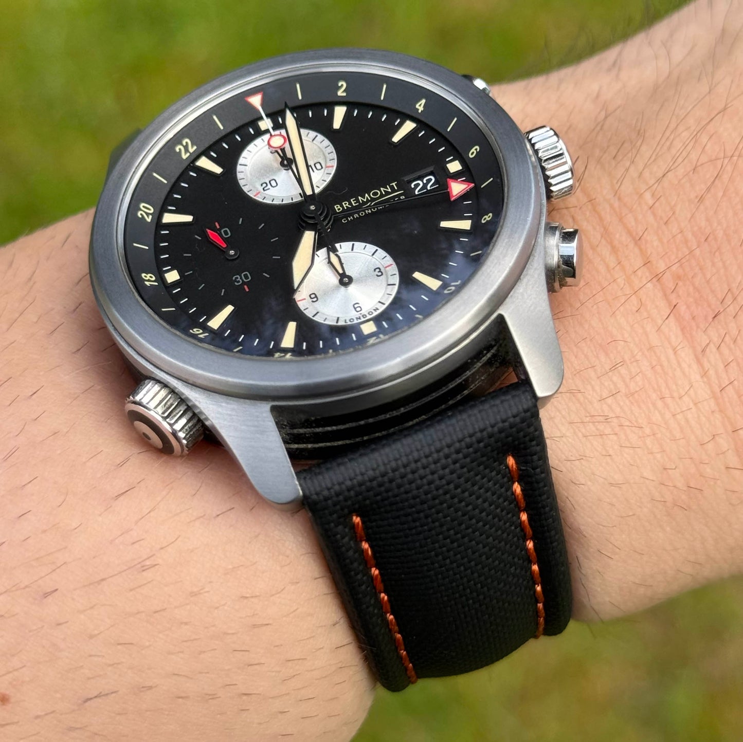 Wrist shot of the Bermuda jet black sailcloth watch strap with orange stitching. 19mm, 20mm, 21mm, 22mm. Watch And Strap
