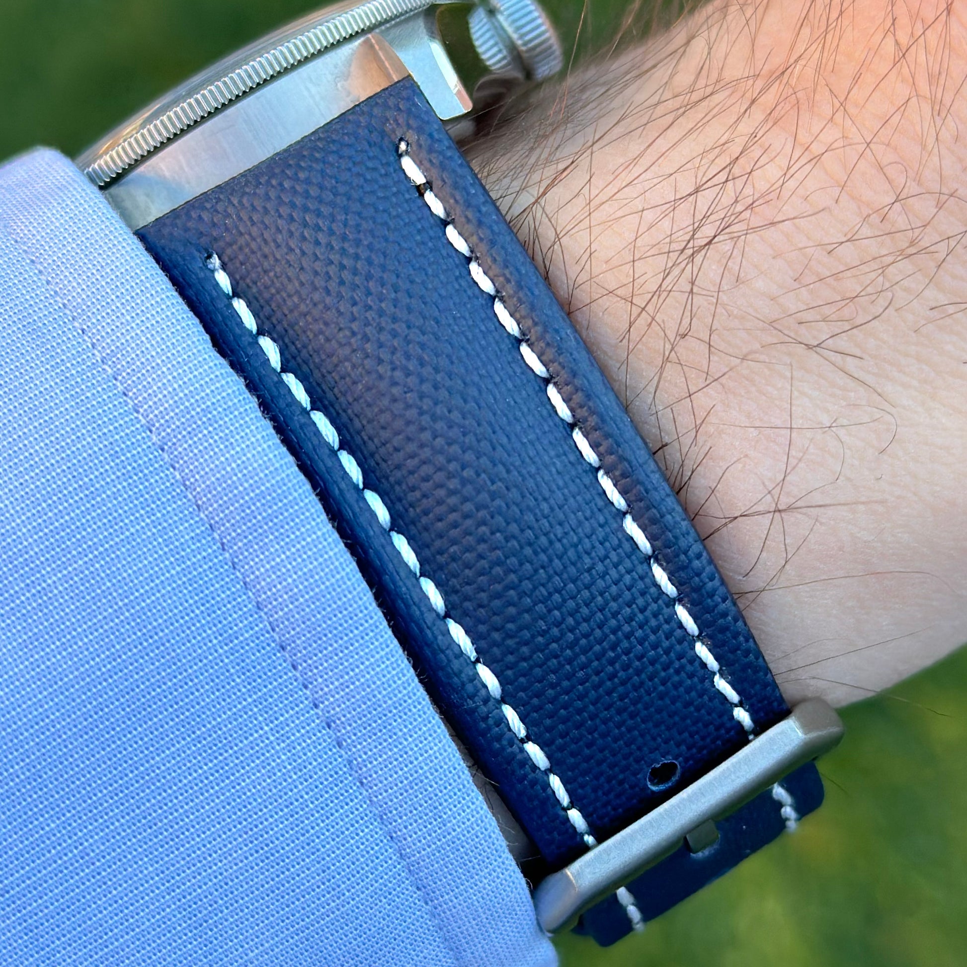 Wrist shot of the Bermuda navy blue sail cloth watch strap with white stitching. On the Tudor Blackbay 58. Watch And Strap.