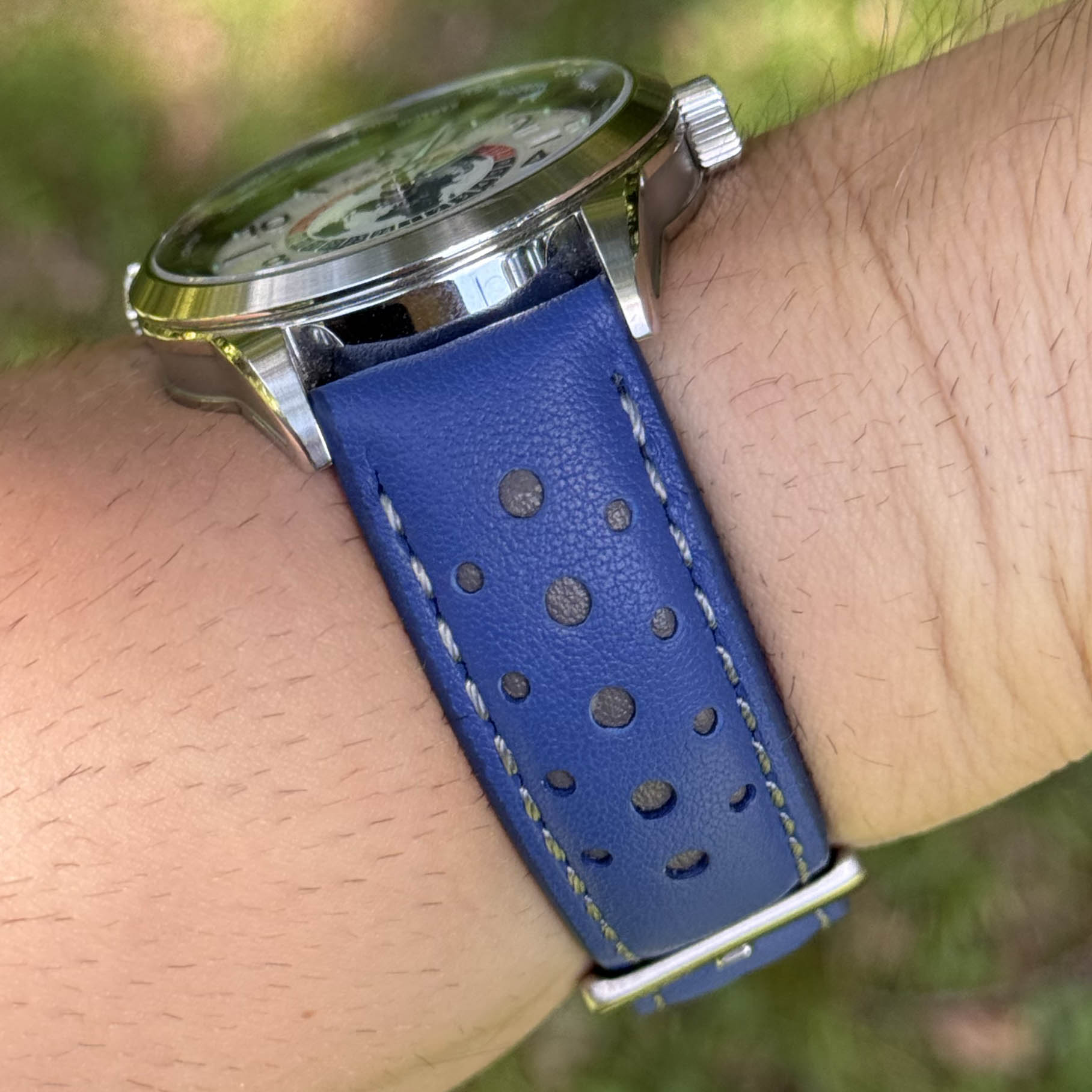 Le Mans blue and grey full grain leather racing watch strap on a males wrist. 18mm, 20mm, 22mm, 24mm.