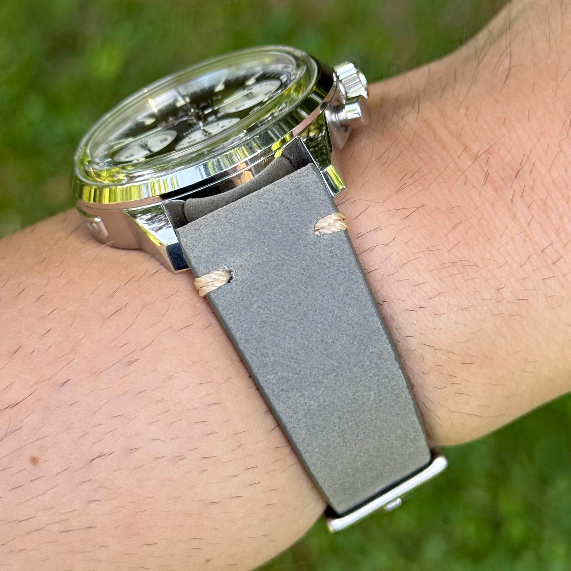 Wrist shot of the Madrid grey full grain leather watch strap. Contrast ivory stitching. Watch And Strap