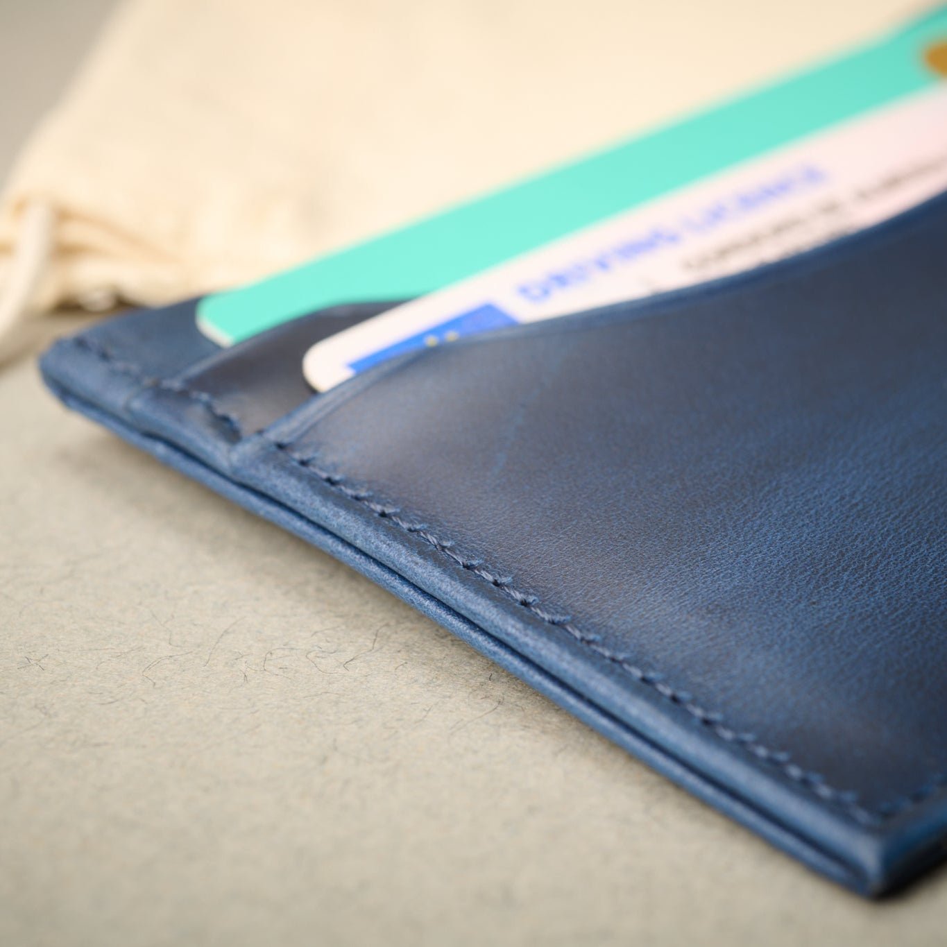 Close up of the Oxford blue full grain calf skin card case. Complete with cards. RFID Blocking Technology.