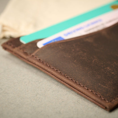 Close up of the Oxford brown full grain calf skin card case with cards. RFID blocking technology.