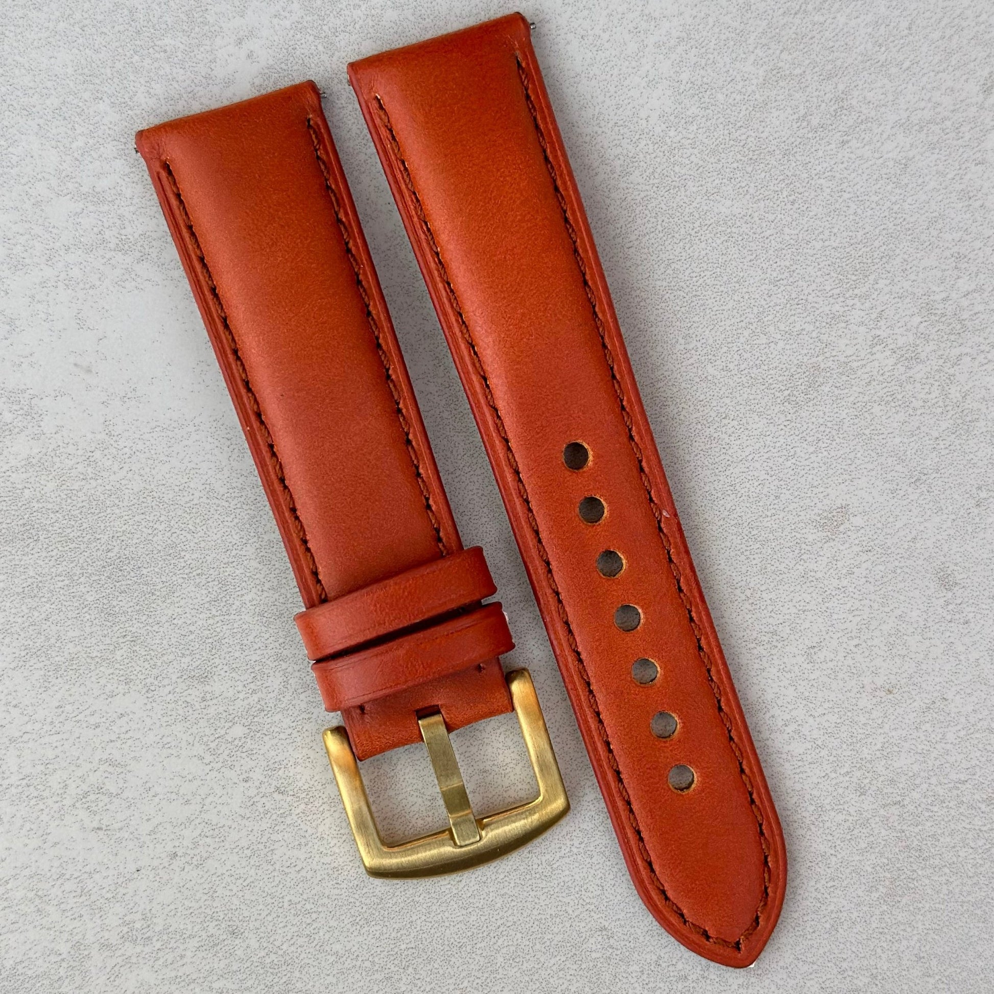 Athens burnt cinnamon full grain leather watch strap with a PVD gold brushed stainless steel buckle.