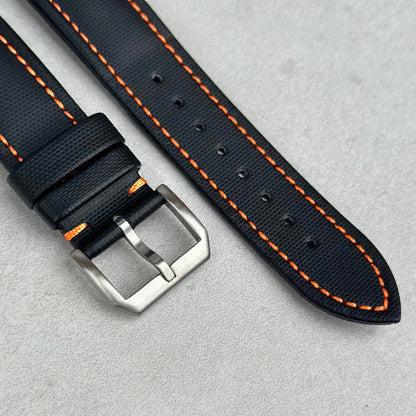 Brushed 316L stainless steel buckle on the Bermuda jet black sail cloth watch strap. Contrast orange stitching.