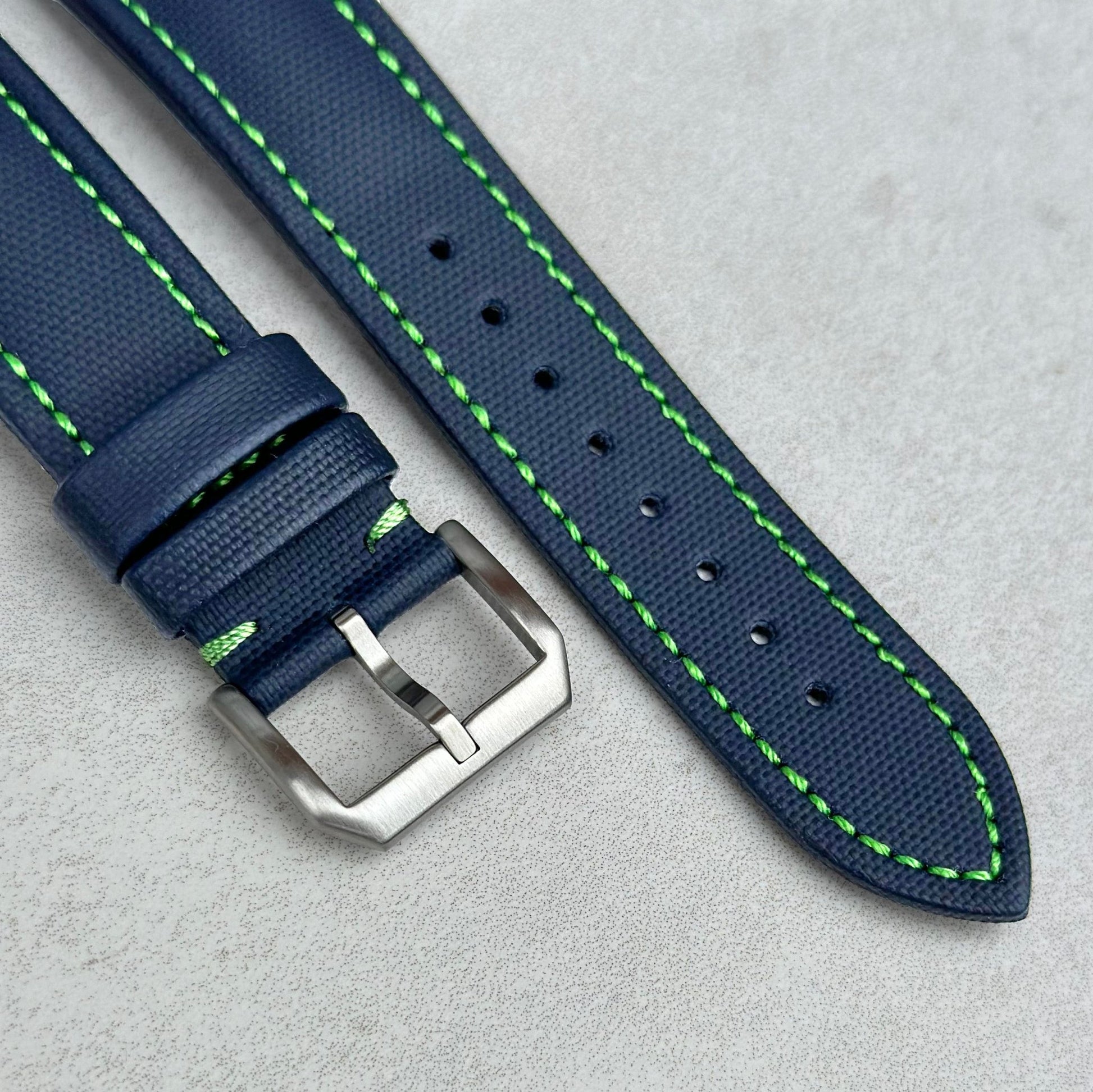 Brushed 316L stainless steel buckle on the Bermuda navy blue sail cloth watch strap. Contrast green stitching.
