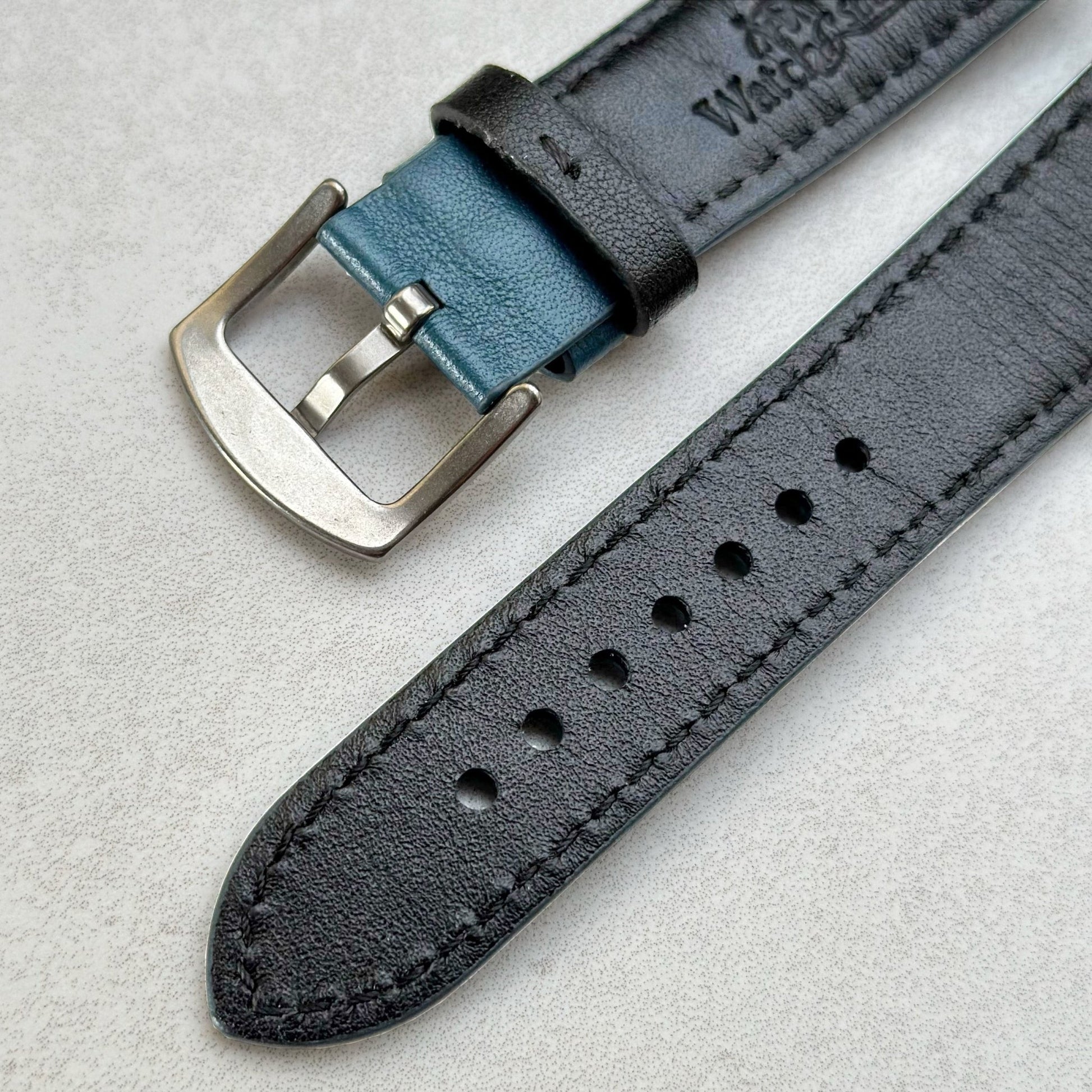 Rear bottom of the Le Mans blue and black full grain leather watch strap. Underside of the 316L stainless steel buckle.