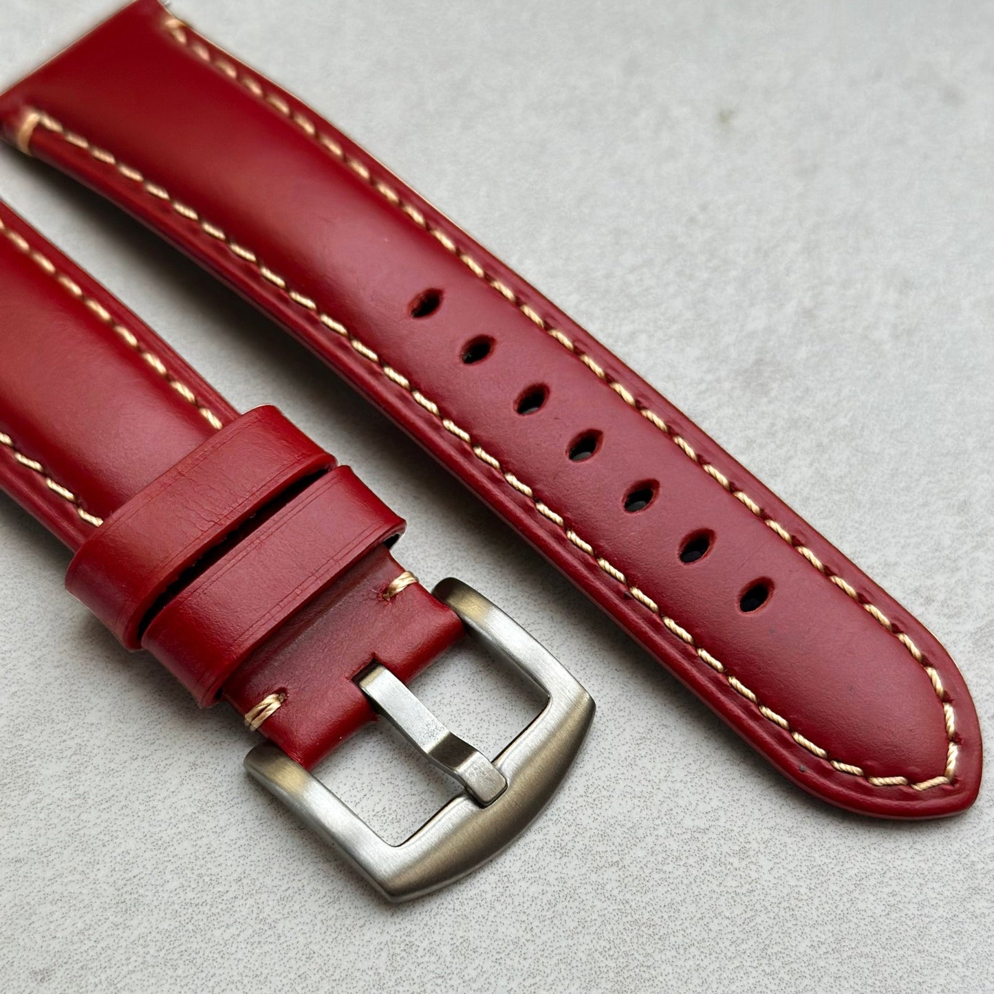 Brushed 316L stainless steel buckle on the Oslo blood red full grain leather watch strap. Contrast ivory stitching. 