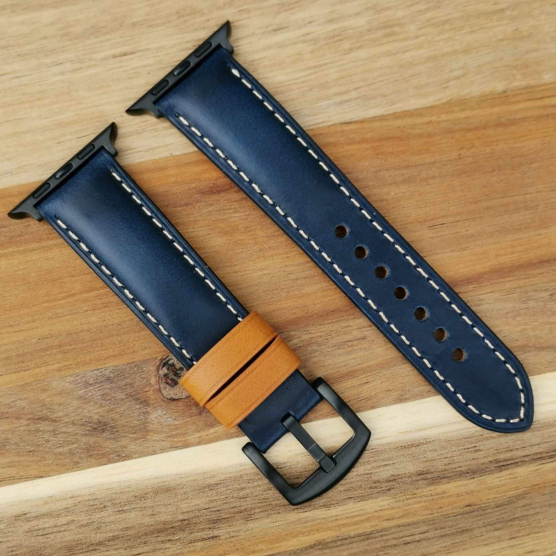Oxford navy blue full grain leather apple watch strap with iodized black stainless steel buckle and apple watch connectors.