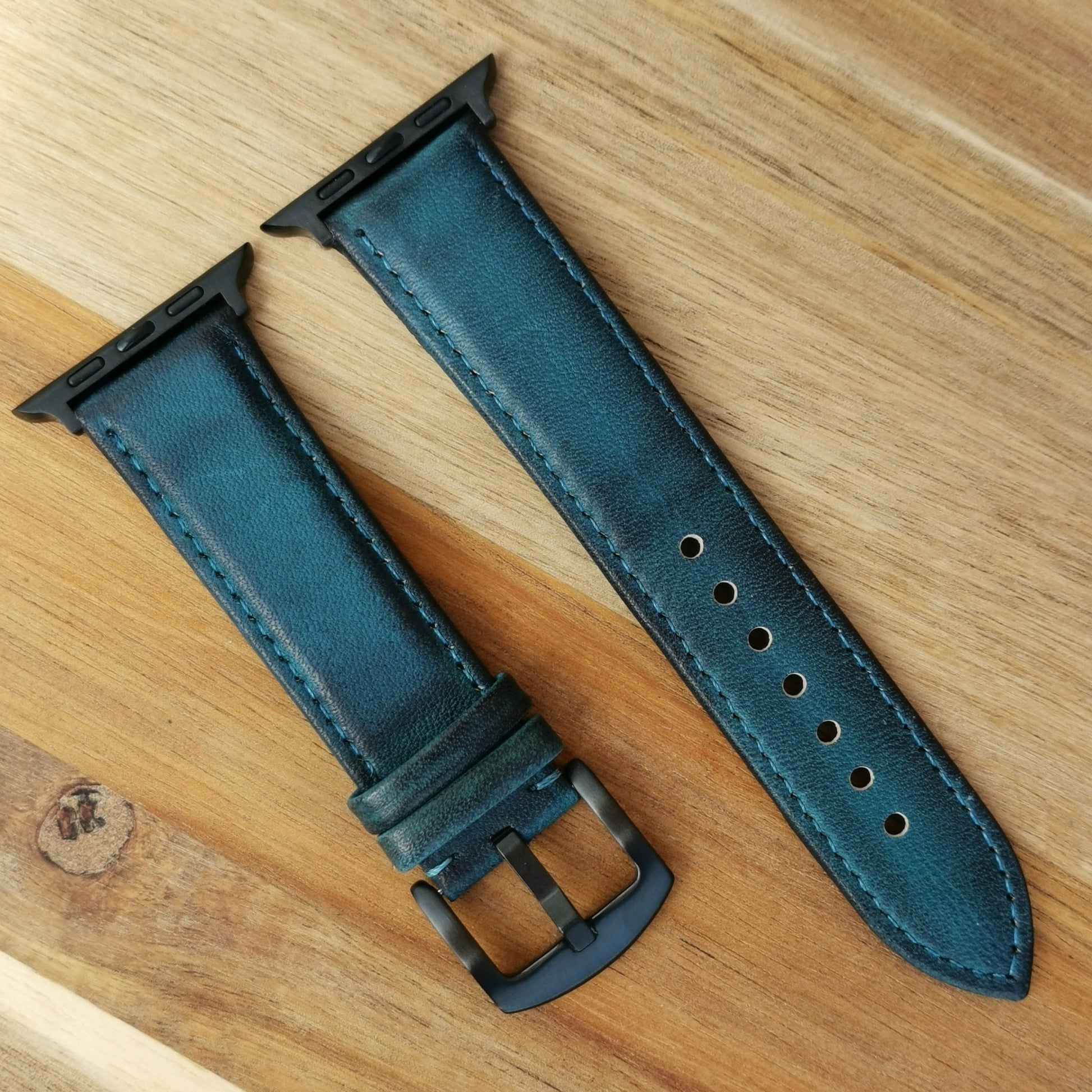 Milan blue vegetable tanned leather apple watch strap fitted with black stainless steel hardware. Will fit Apple watch series 3, series 4, series 5, series 6, series 7, series 8, SE, ultra.