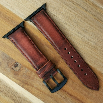 Milan brown vegetable tanned leather apple watch strap with an iodized black 316L stainless steel buckle.