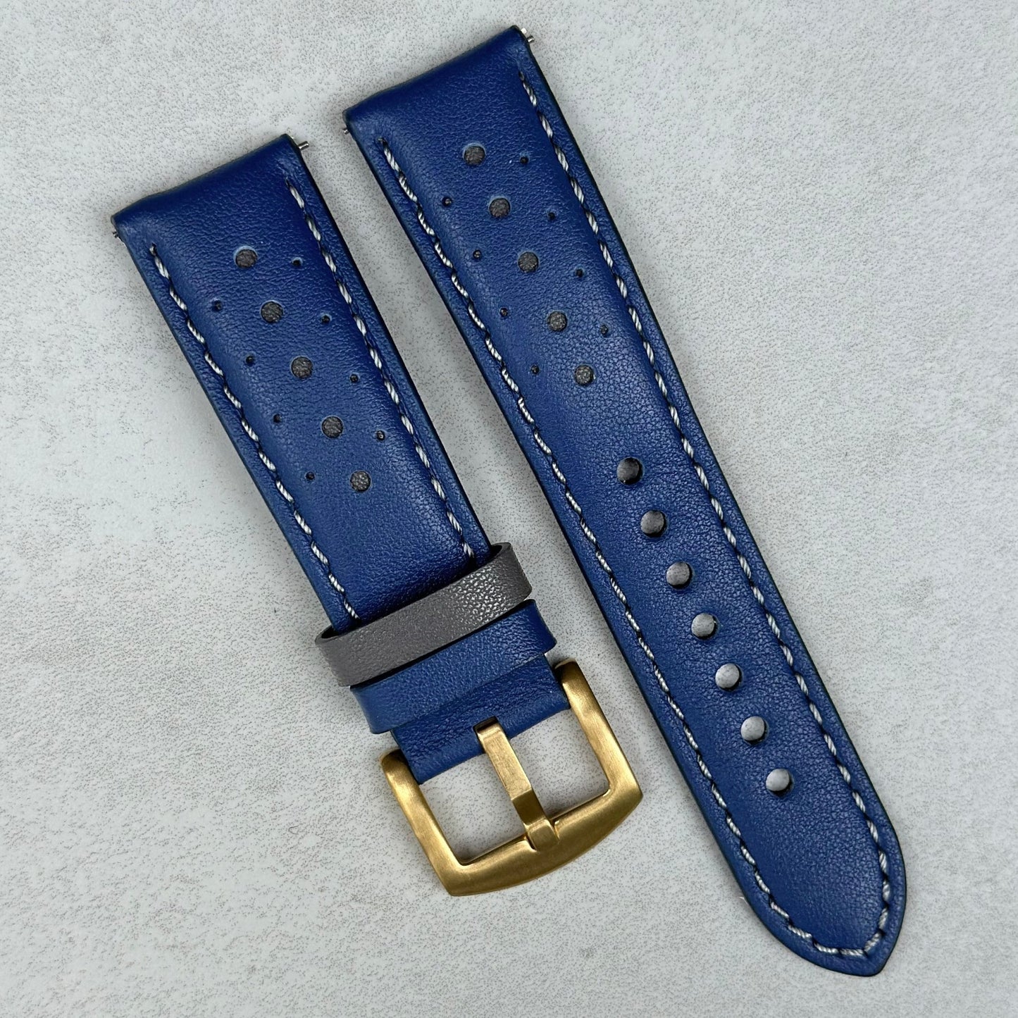 Le Mans blue and grey full grain leather racing watch strap. Brushed gold buckle.
