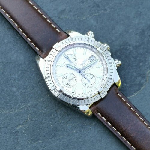 Oxford brown full grain leather watch strap on the Breitling Evolution Chronomat. Placed on a slate background.