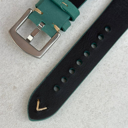 Underside of the brushed 316L stainless steel buckle on the Caribbean blue full grain leather watch strap.