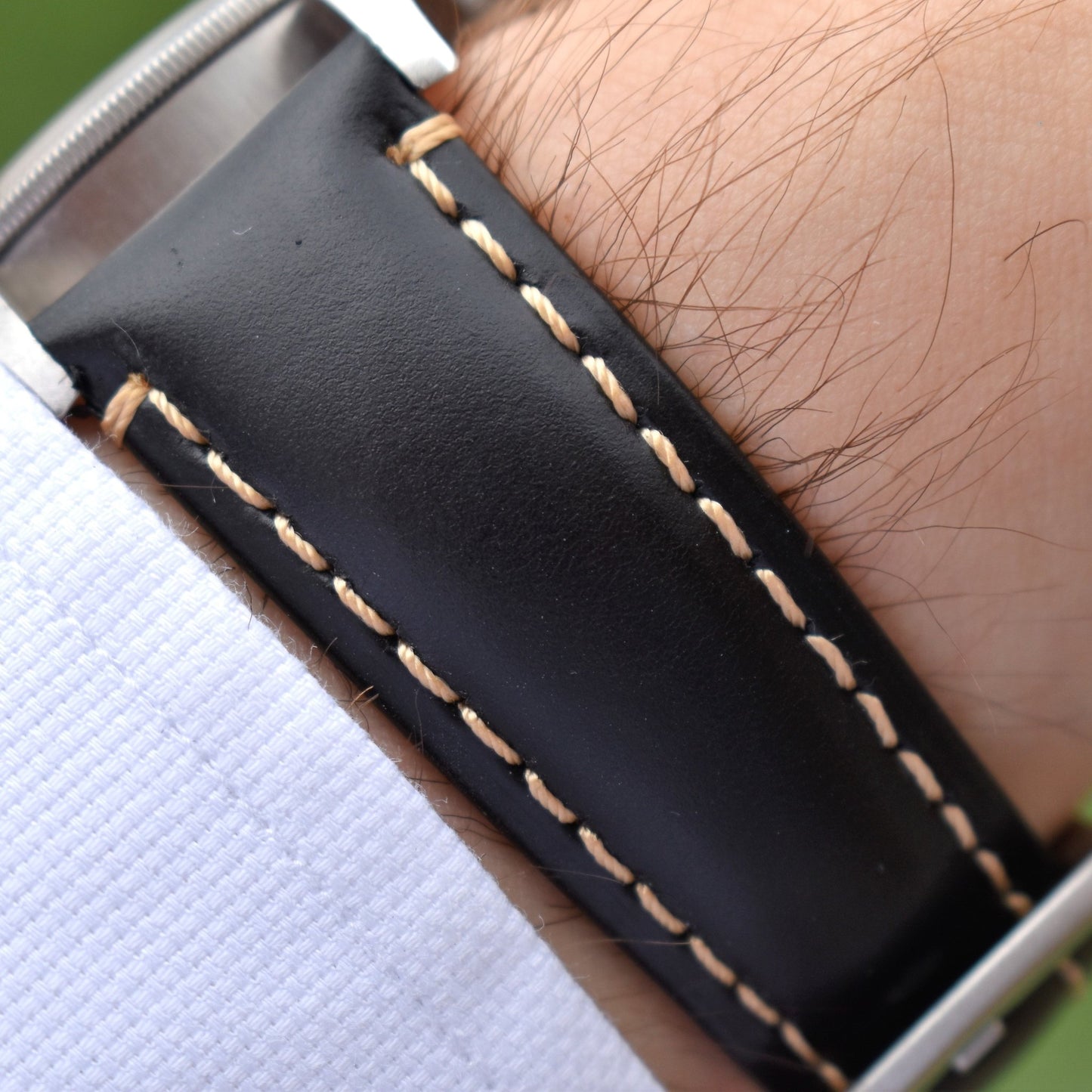 Wrist shot of the Oslo black full grain leather watch strap with ivory stitching. Tudor Blackbay 58. Watch And Strap