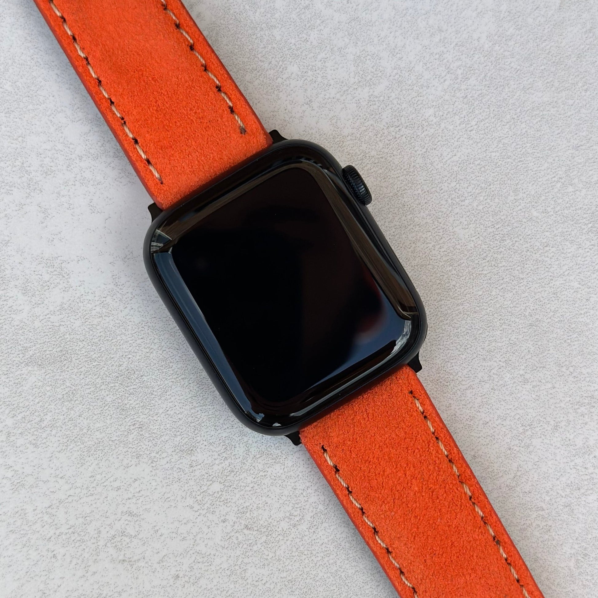 Paris orange suede Apple Watch strap on the Apple Watch Series 9. Ivory stitching. Series 3, 4, 5, 6, 7, 8, 9, SE and ultra.