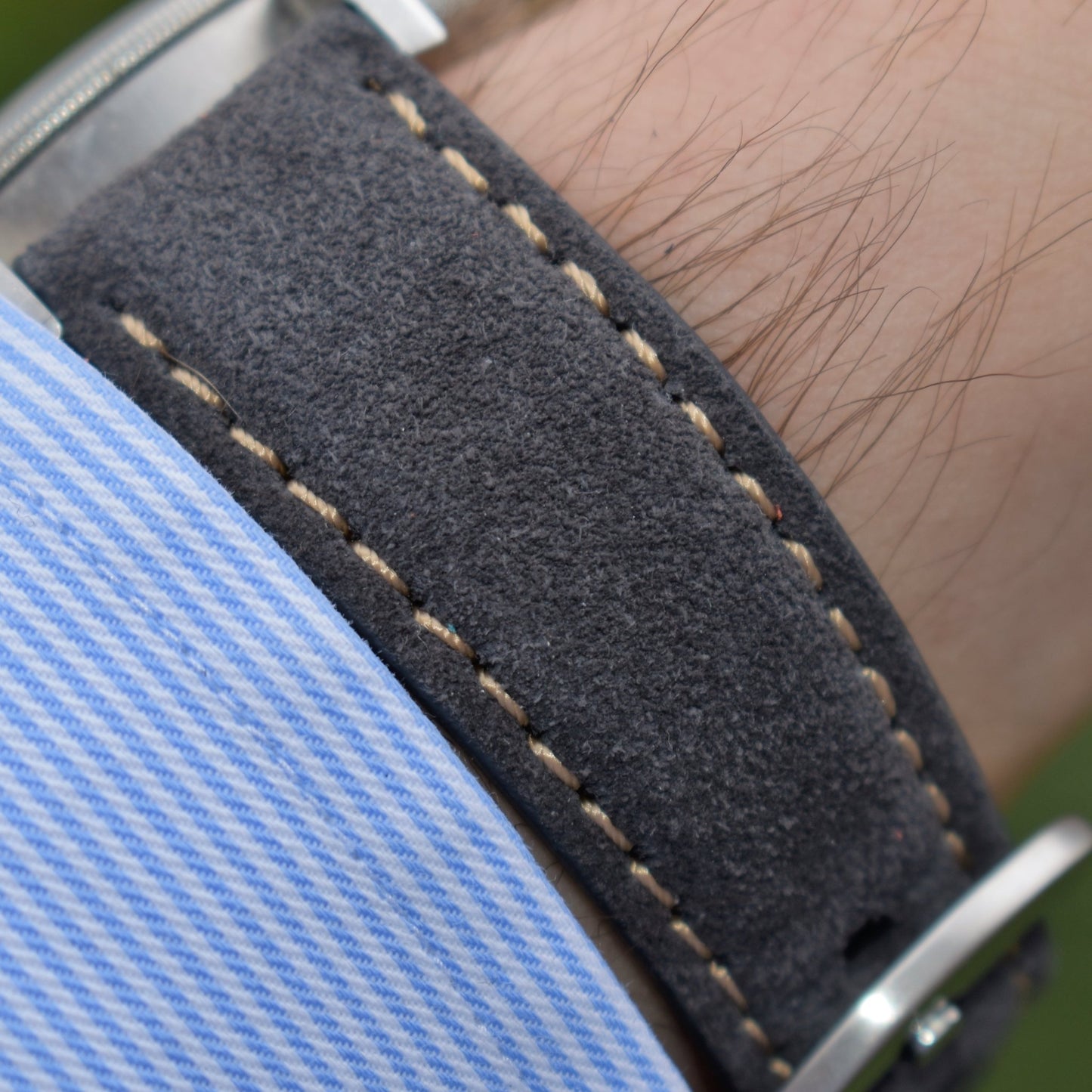 Wrist shot of the gunmetal grey suede apple watch strap. With contrast ivory stitching. Watch And Strap