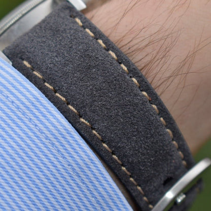 Wrist shot of the Paris gunmetal Grey suede watch strap with contrast ivory stitching. 